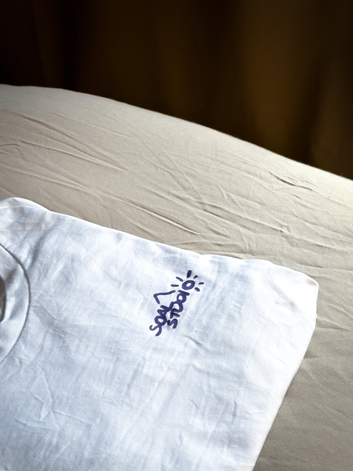 White SOAL Studio with purple Dragon print on beige and brown bedroom sheet