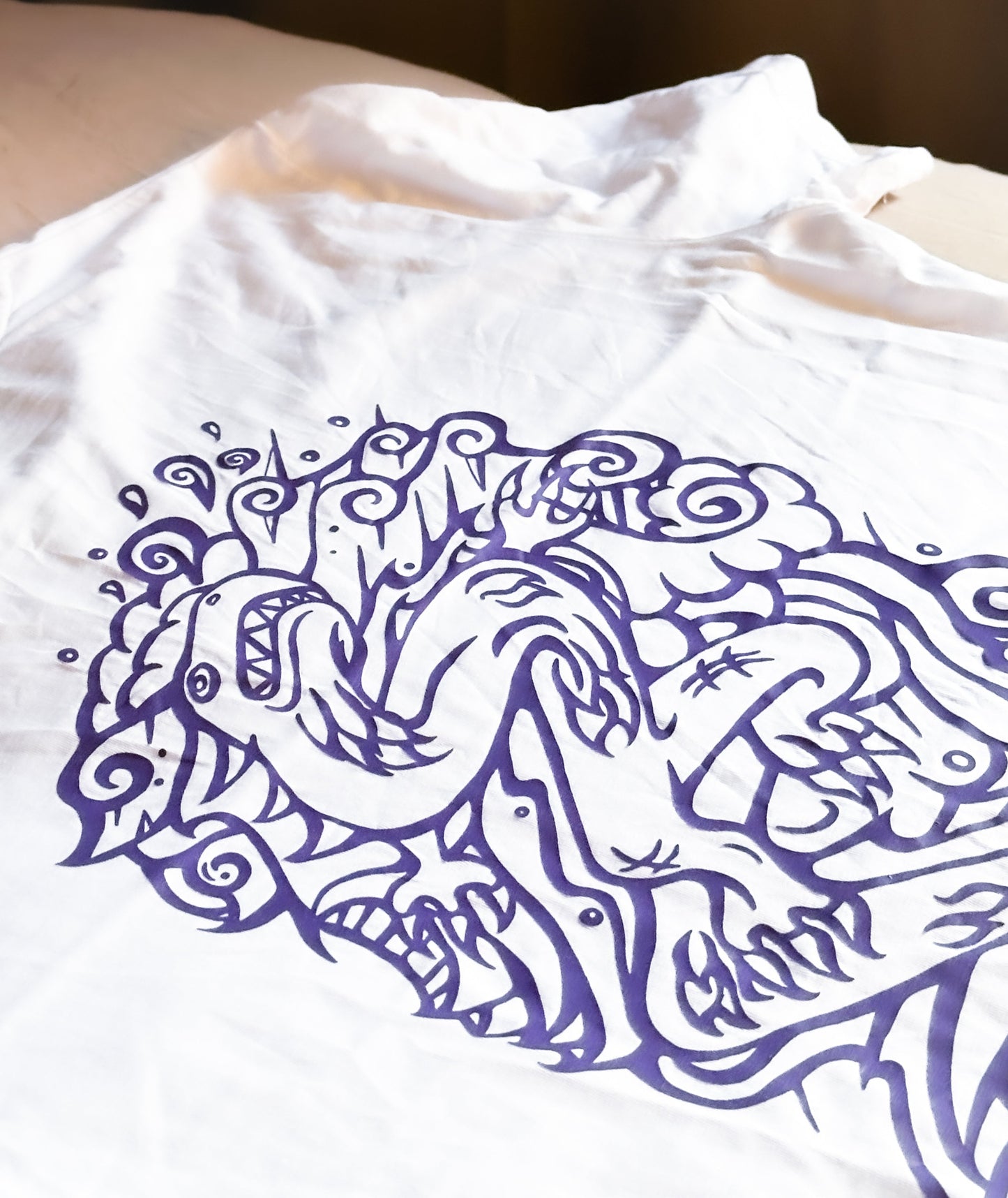 White SOAL Studio t-shirt with purple dragon art design on a white background