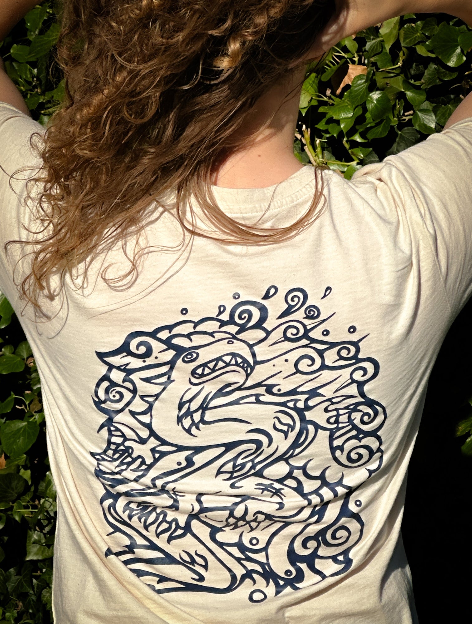 SOAL Studio batch 1 Female red haired model wearing a white t-shirt with a blue dragon design outdoors. Drawn by Alantherock